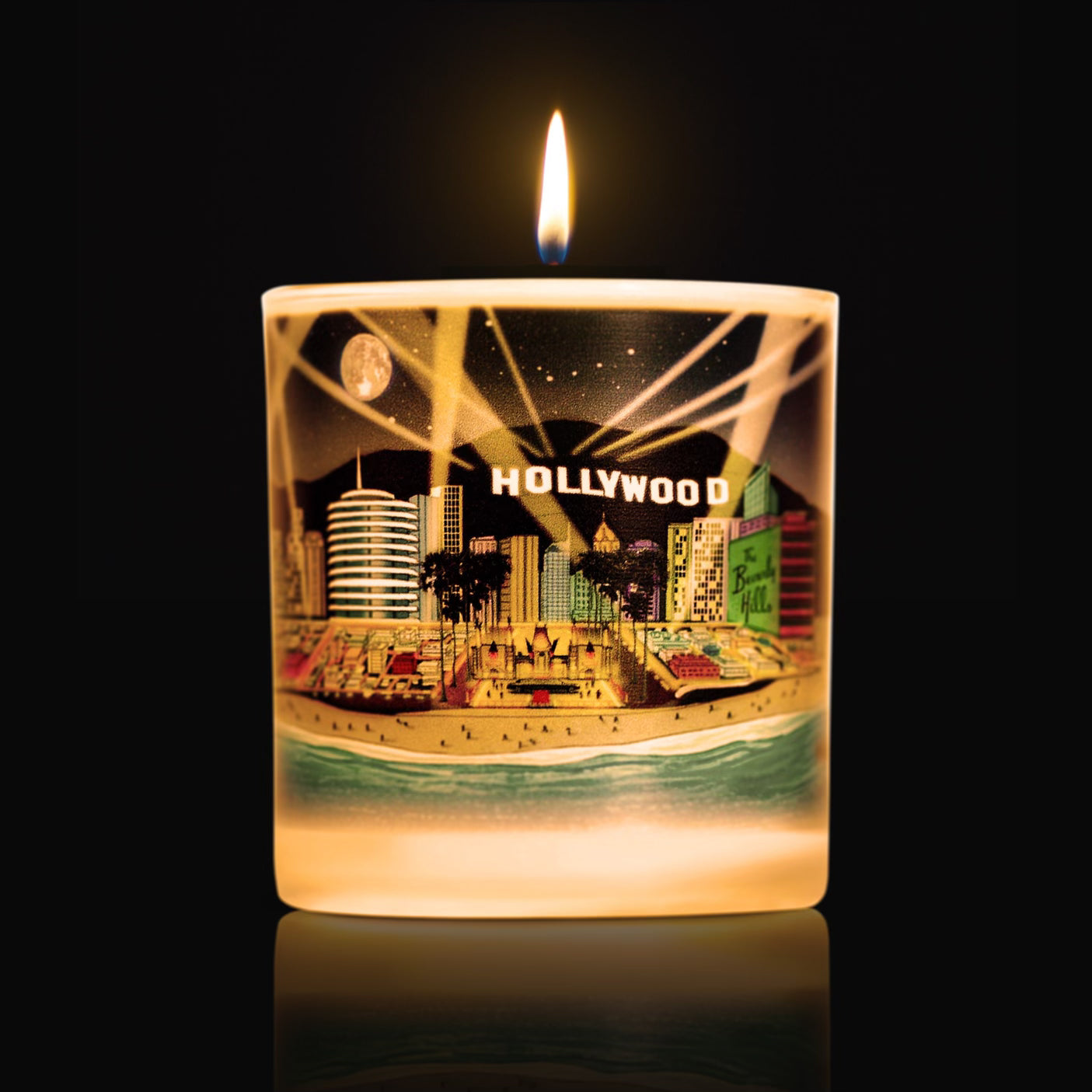 Lit Luxury candle with artwork of famous hollywood landmarks