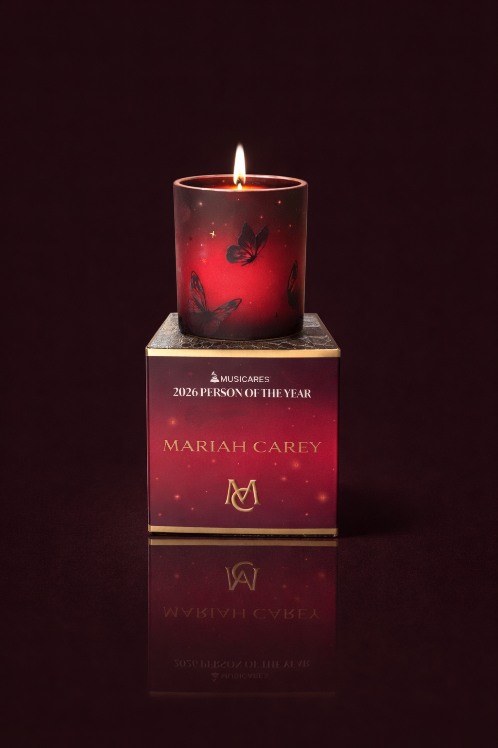 Matron Saint for Mariah Carey pink glass candle with butterflies lit gold rim and stars