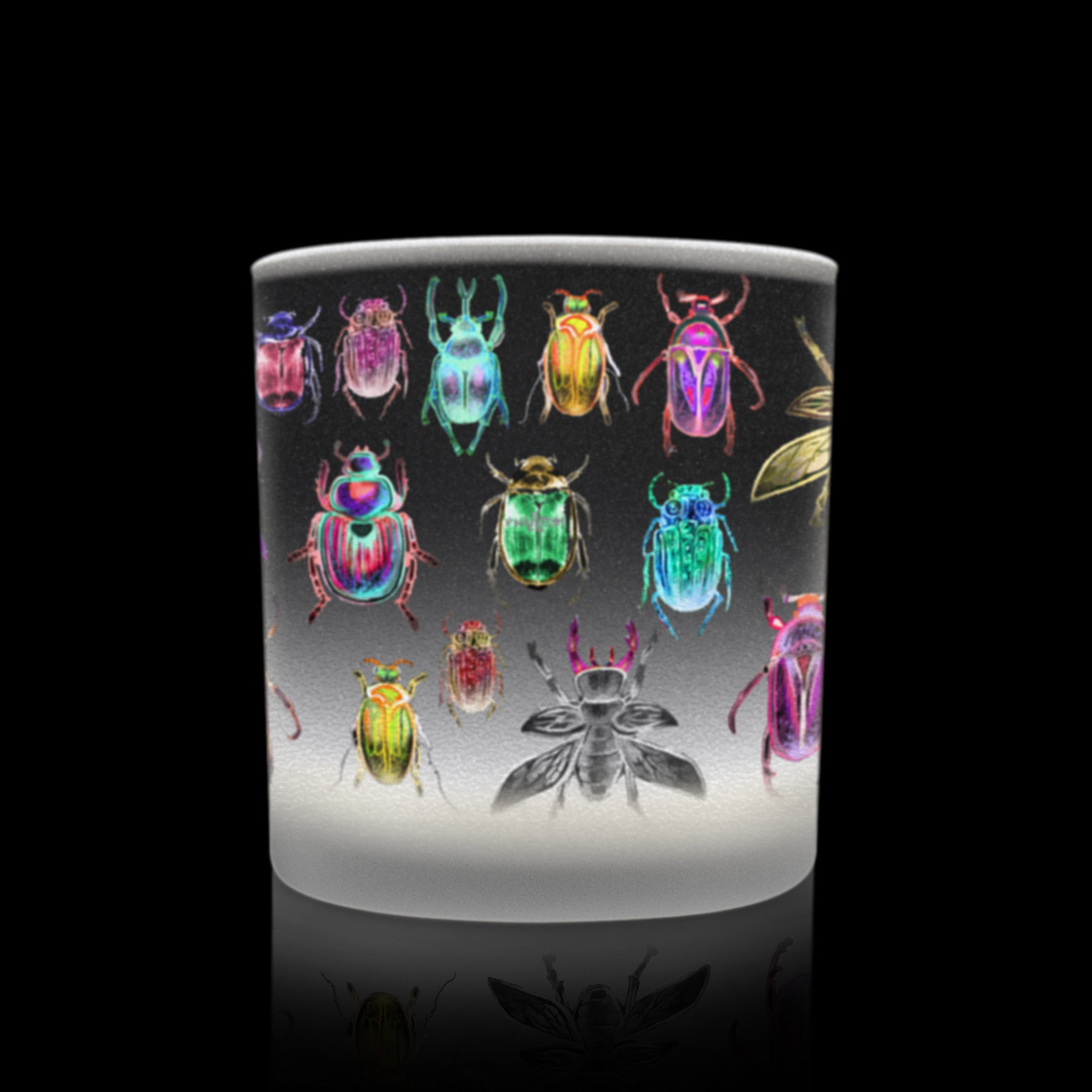 Candle with colorful beetle illustrations on frosted glass