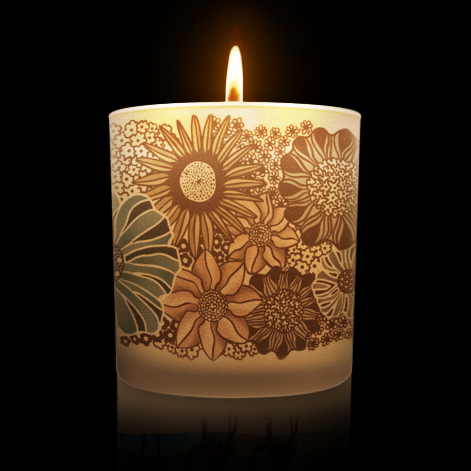 lit candle with a modern floral pattern on a frosted glass