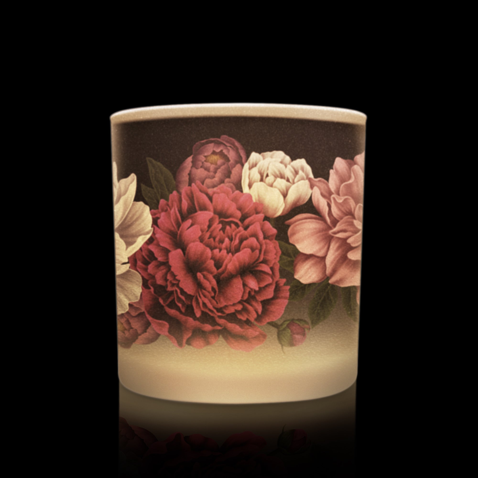 Candle with floral design on a black background