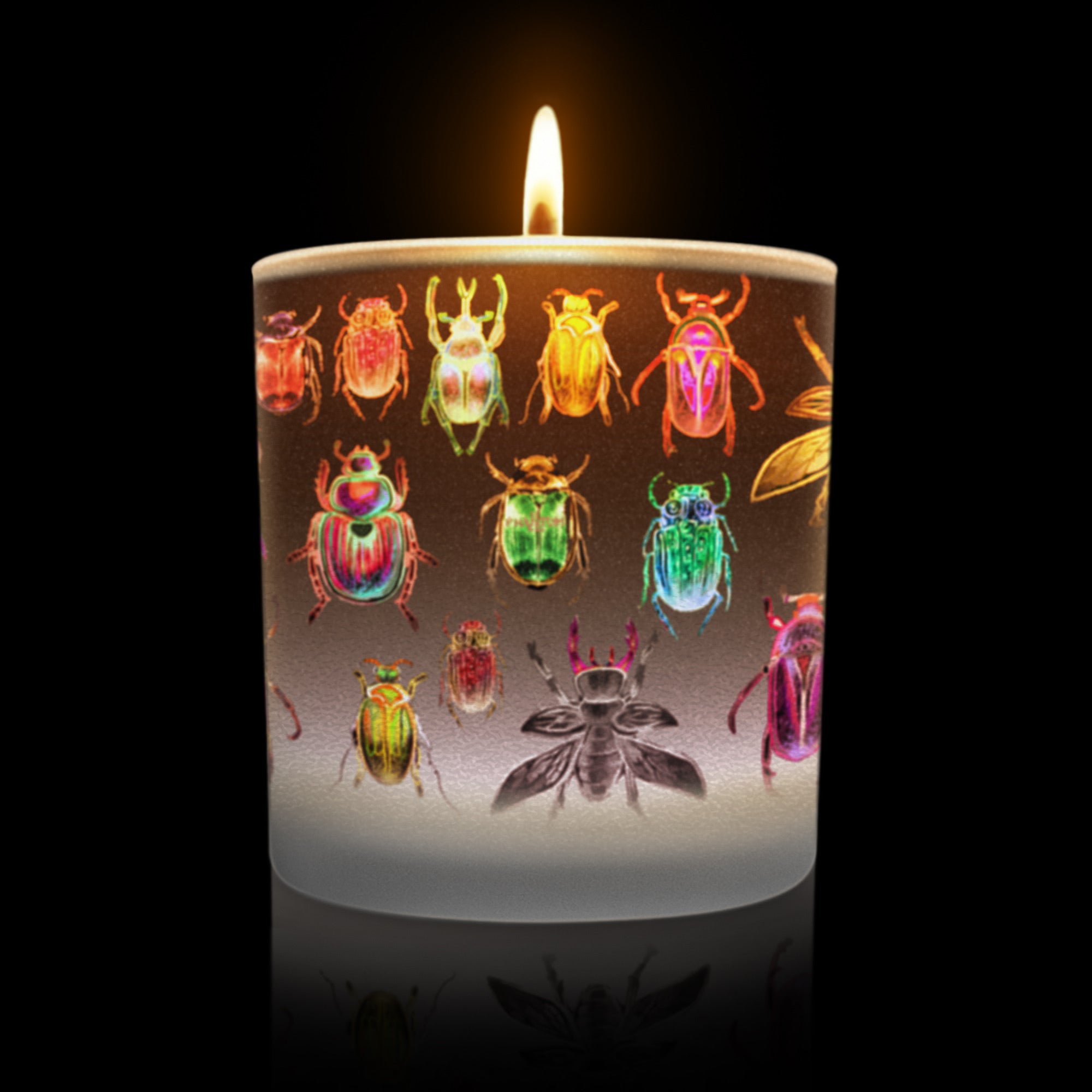 Lit candle featuring glowing colorful beetle artwork