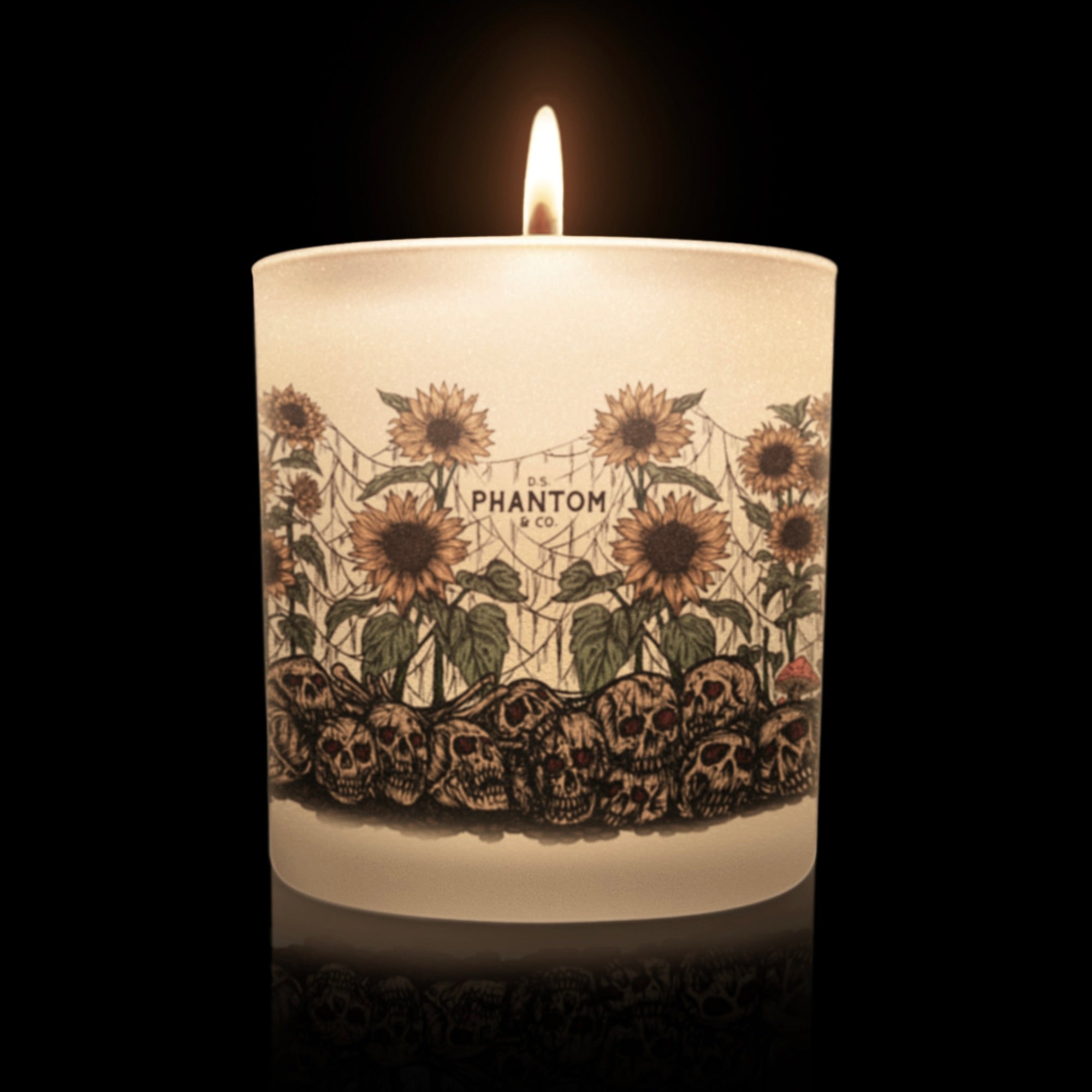Lit candle with sunflower and skull design  