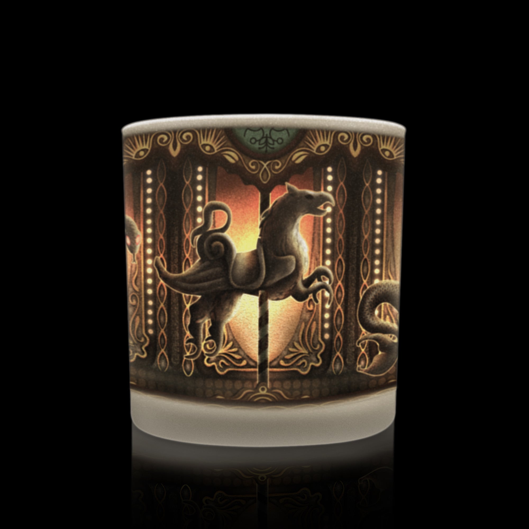 Candle with glowing gothic carousel artwork in warm tones