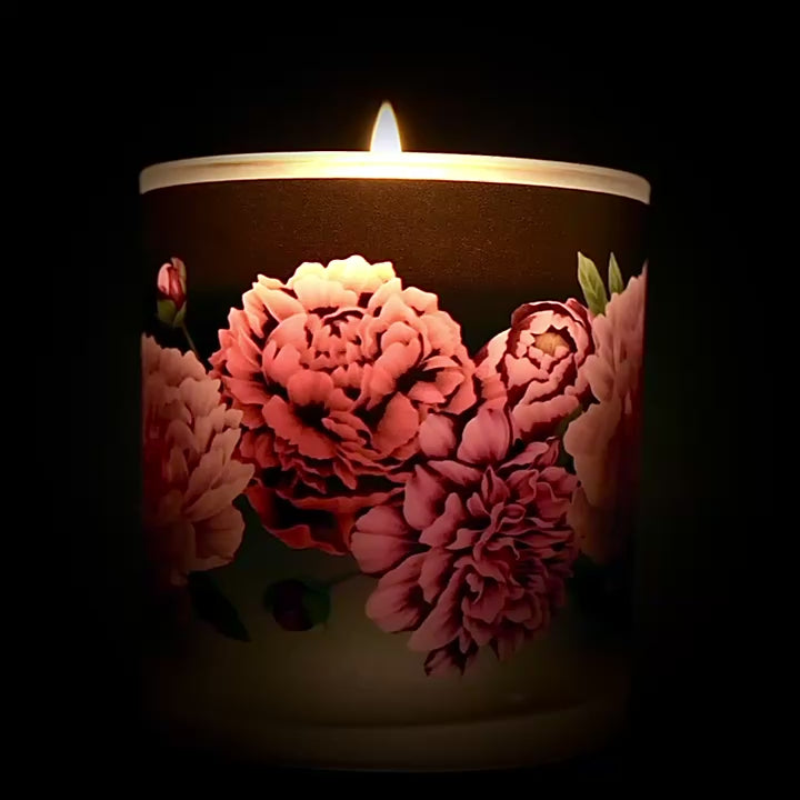 360 video of a candle with a floral pattern on black background
